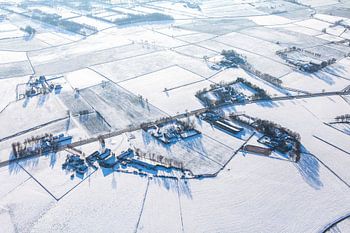 Winter aerial view of Achterveld with snow-covered farmhouses