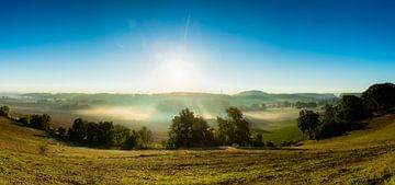 herfstochtend panorama over de Jekervallei met mist en zonneharpen van Kim Willems
