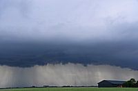 Rolling cloud and precipitation at a barn