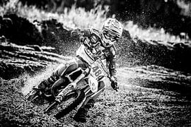 Motorcrosser sur la vitesse dans le virage sur Karel Pops