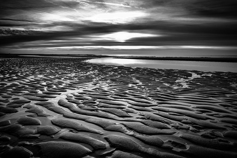 Beach with shapes and patterns at a sunset by eric van der eijk