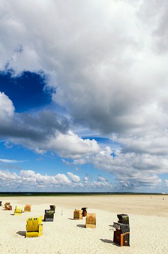 Beach chairs on the North Sea beach under clouds