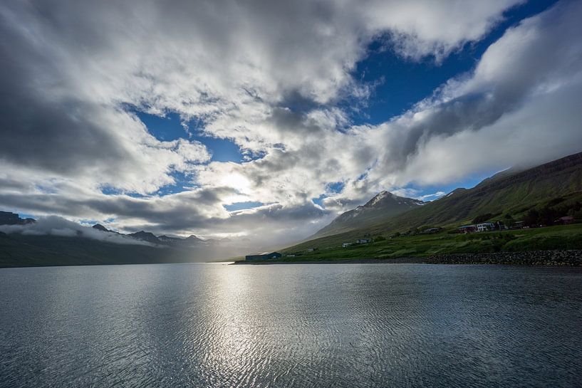 Iceland - Fjord between green mountains and houses in magical light of the sun by adventure-photos