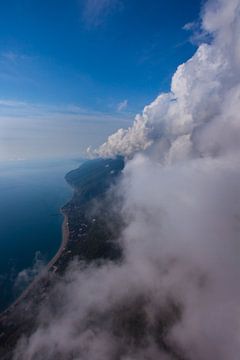 vlucht bij de wolkenmuur, vrije vlucht. Muur van wolken, blauwe lucht en zee. Parapente vlucht