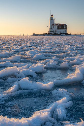 Lighthouse in frozen lake