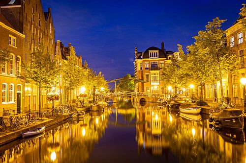 Leiden, Netherlands - July 22, 2020: Cityscape Leiden view Old Rhine with canal, houses and bridge d