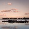 Boats at sunset van Trudy van der Werf