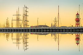Harlingen harbour seen from the beach at sunset by Harrie Muis