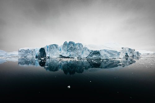 Ice floe in black ocean with ominous sky