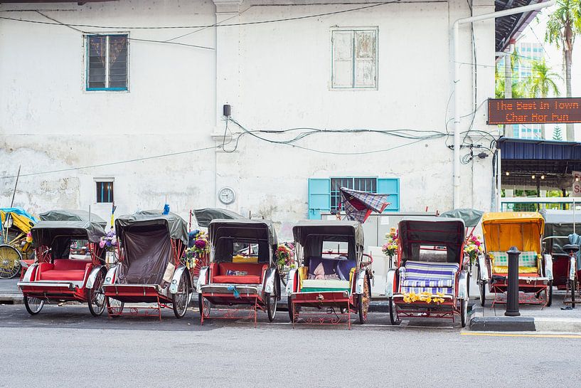 Queue of Rickshaws waiting for customers in Georgetown by Elles Rijsdijk