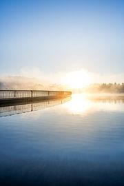 Fine art landscape of a hushed misty sunrise near a bridge