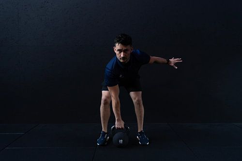 A man working out at a fitness club, lifting weights