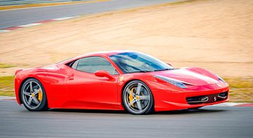 Red Ferrari 458 Italia sports car driving on a race track by Sjoerd van der Wal Photography