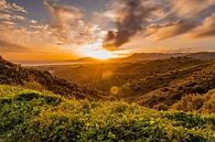 Beautiful sunbeams over the sea and mountains by Dafne Vos thumbnail