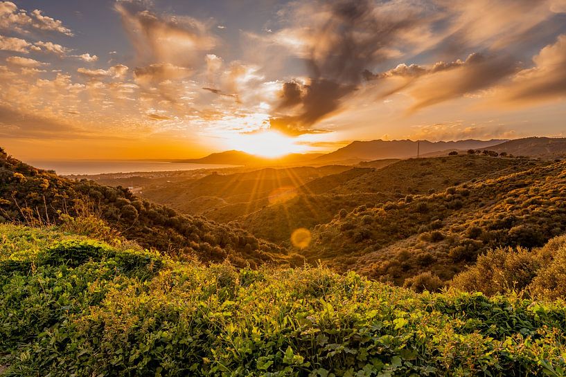 Beautiful sunbeams over the sea and mountains by Dafne Vos