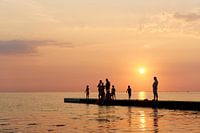 People at the seaside during sunset