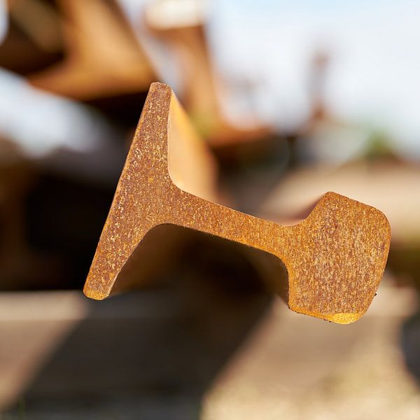 Rusting railway rails in a storage yard by Heiko Kueverling