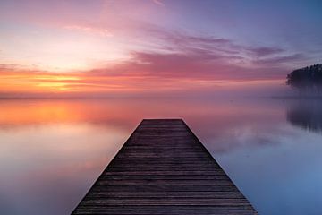 Jetty in Lake Dirkshorn during misty sunrise by Bram Lubbers