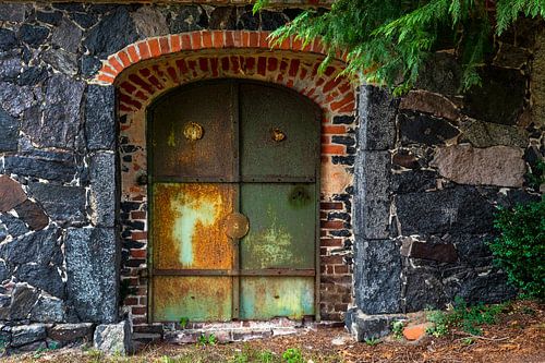 Old, rusty iron door in old walls