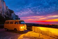 Hippie van Volkswagen T2 during powerful sunset in Normandy, France near the beach with