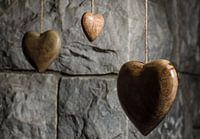 Wooden hearts and old stone wall