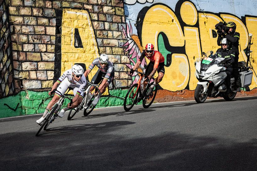 Tadej Pogacar dives into the descent of the Cipressa in the lead by Leon van Bon