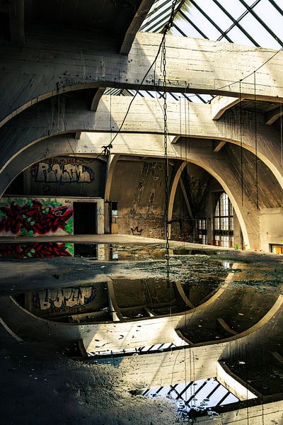 Abandoned hall with reflections and graffiti - symmetry and decay in a lost place by Infinite Decay
