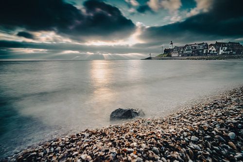 Shell beach at IJsselmeer with clouds and sun