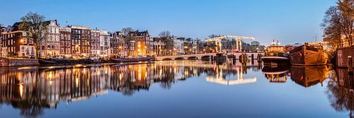 Canal houses on the Amstel river in Amsterdam, the Netherlands.