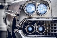 Classic white Chevrolet Bel Air with blue headlights and metal grille