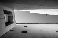 Black and white photo of a sleek architectural building with window