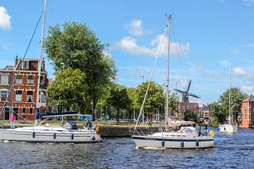 dutch landscape with boats and windmill