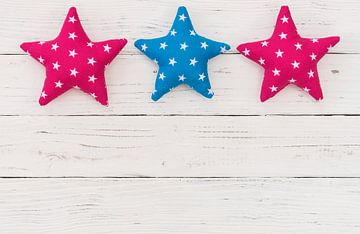Fabric stars on white background with copy space by Alex Winter