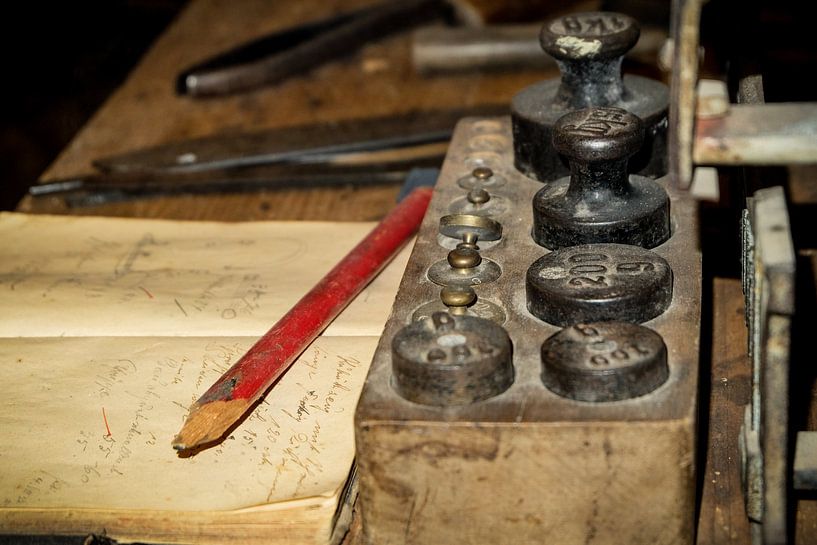 Vinatge desk in old garage with ancient weights, notes and old pencil by pixxelmixx