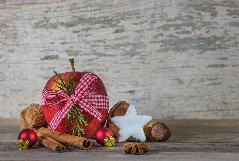 Traditional Christmas decoration with red apple, nuts, star biscuit, cinnamon by Alex Winter