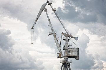 Giant old crane against dark sky by Jan Brons