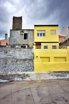 Colorful yellow house dark clouds