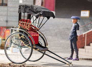 Japanese rickshaw man awaiting for the customers by Yevgen Belich