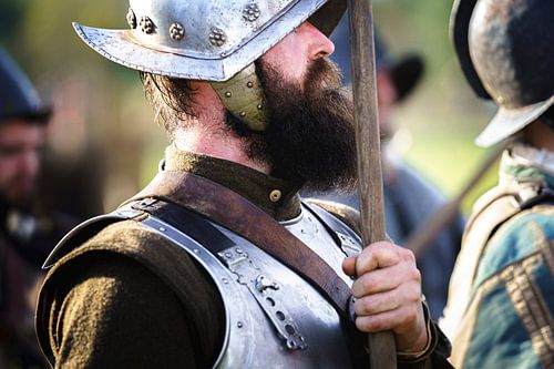Bearded Spanish soldier in medieval armour stands battle-ready in posture