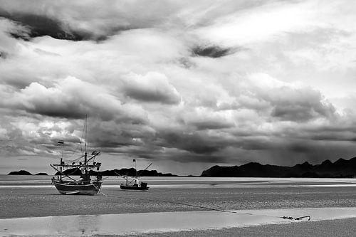 Fishing boat under a stormy sky in black and white