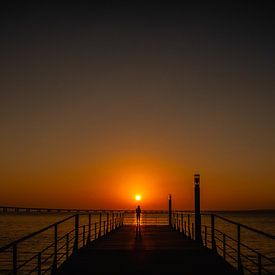 Sunrise Lisbon Portugal Vasco da Gama Bridge, girl alone on the Pier. by Bob Van der Wolf