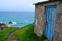 Weathered cottage on a cliff on the rugged English coast