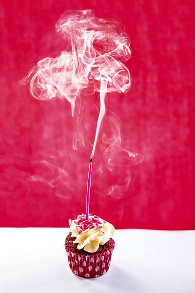 Redvelvet cupcake with a candle out by Dani Teston