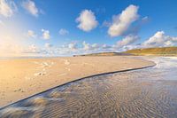 The beach at Hargen aan Zee at low tide with a beautiful sunset. The bright light gives the colours 