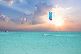 Kite surfing at sunrise on Aruba in the Caribbean Sea by Eye on You