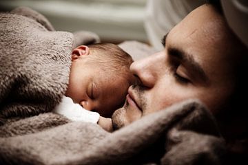 Man with baby under a blanket by Atelier Liesjes