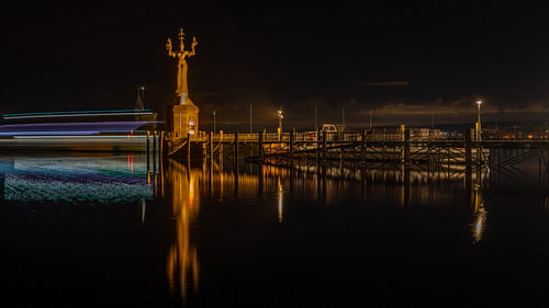 Night-time photograph featuring the illuminated Imperia sculpture