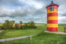 The Pilsum lighthouse on the North Sea coast of Germany. by Jan Schneckenhaus