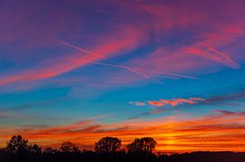 Sunset with amazing colors over the trees during autumn by Sjoerd van der Wal Photography