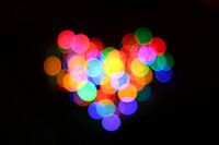 colorful heart made out of round bokeh lights